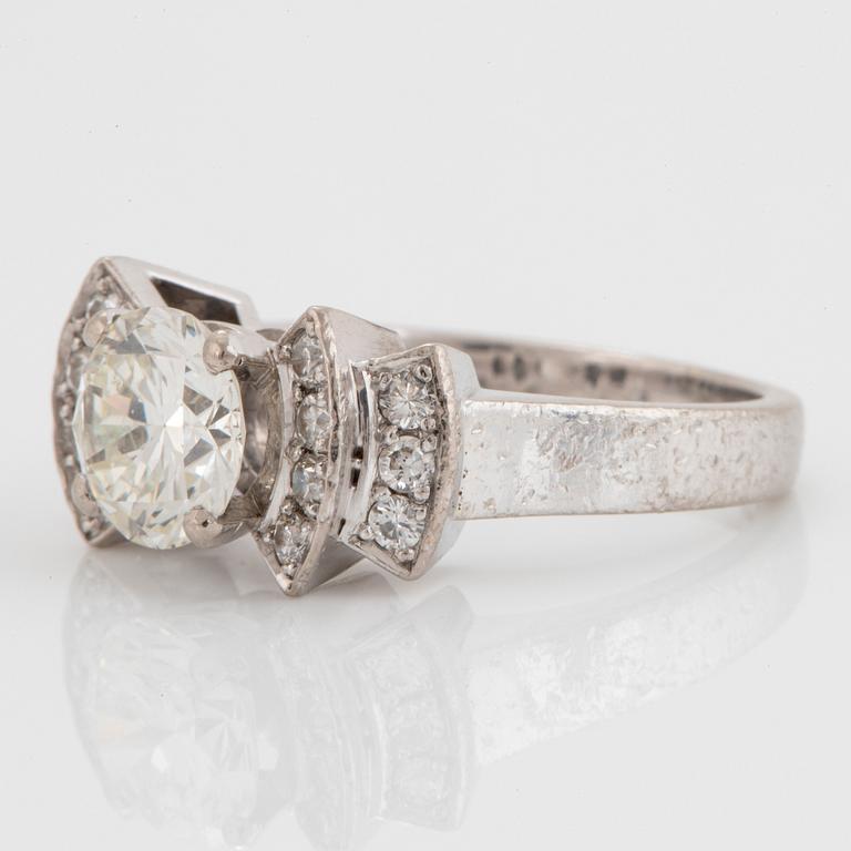 An 18K white gold ring set with an old-cut diamond ca 1.50 cts and round brilliant-cut diamonds.