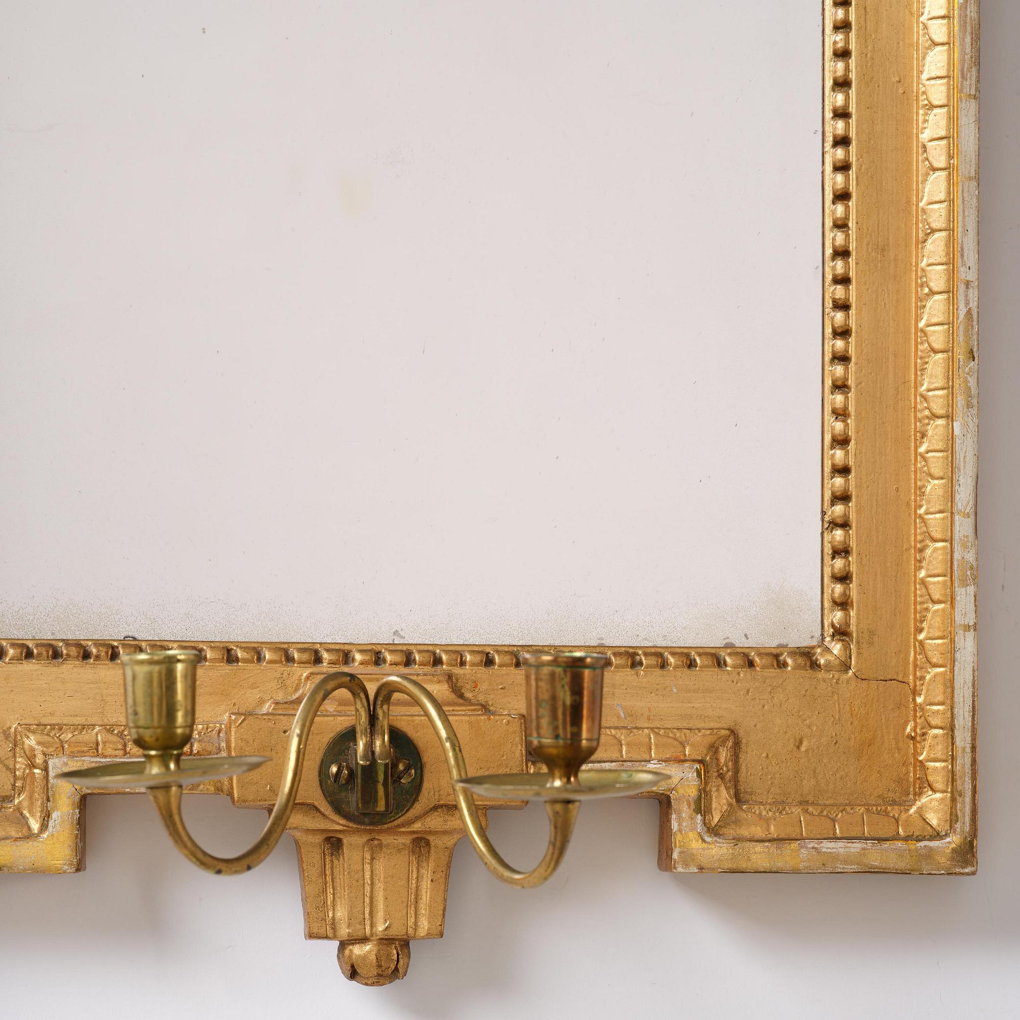 A Gustavian giltwood two-light girandole mirror by J. Åkerblad (master in Stockholm 1754-99).