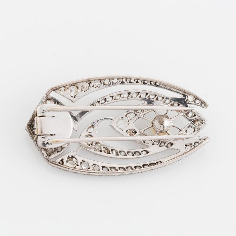 A silver brooch set with old- and rose-cut diamonds and pearls.