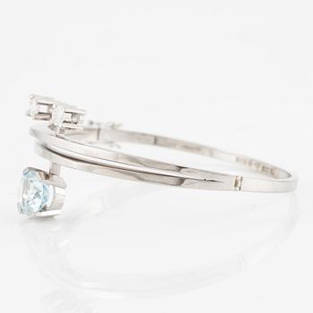 A bangle 18K white gold with aquamarine and two round brilliant-cut diamonds.