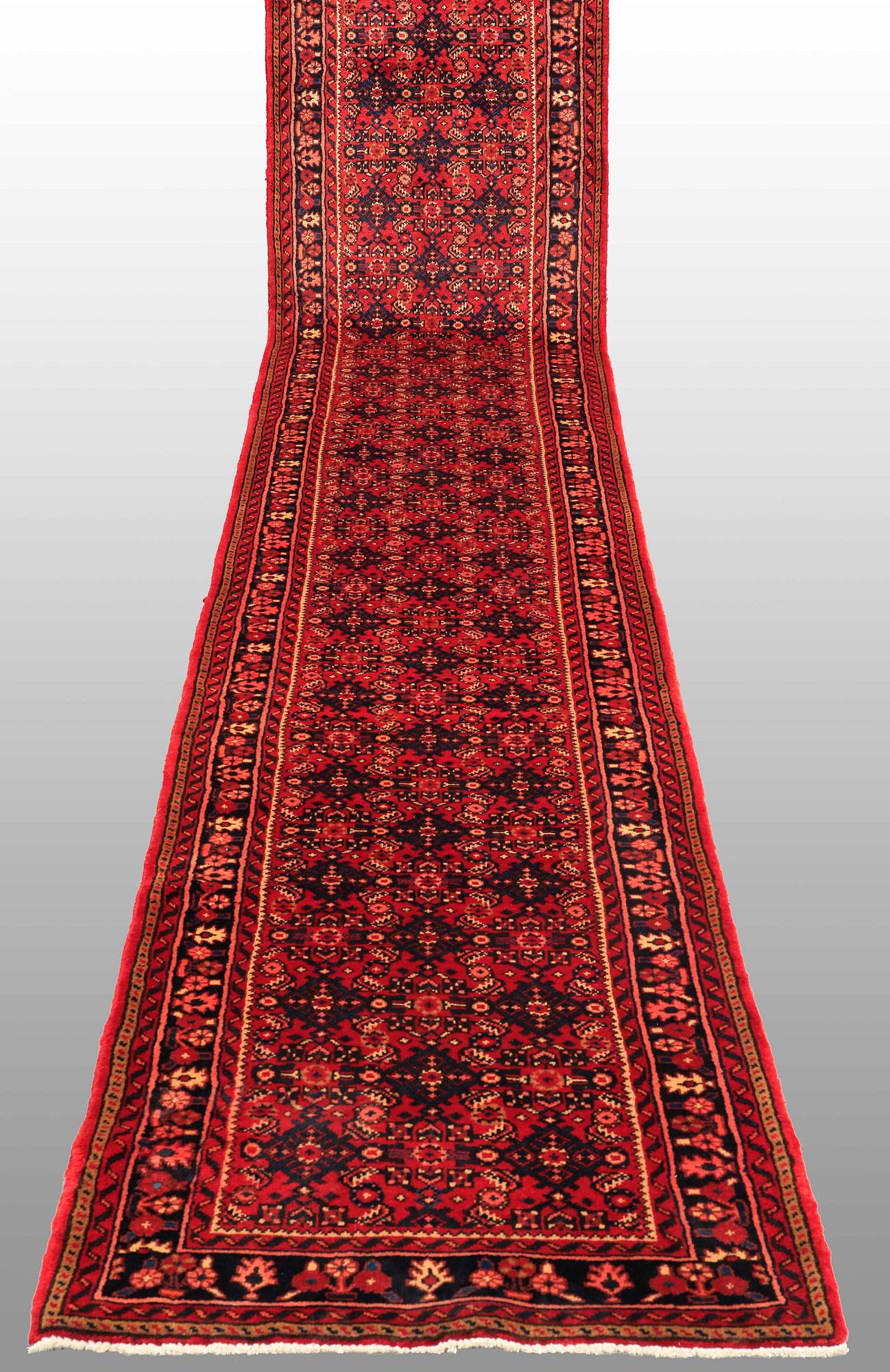 A Hosseinabad runner, c. 605 x 84 cm.