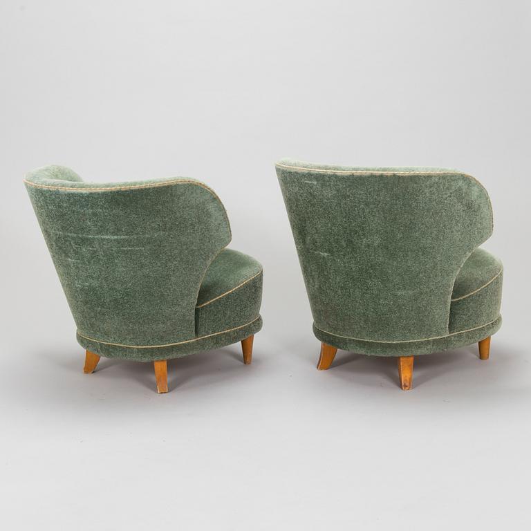 A pair of mid-20th-century armchairs.