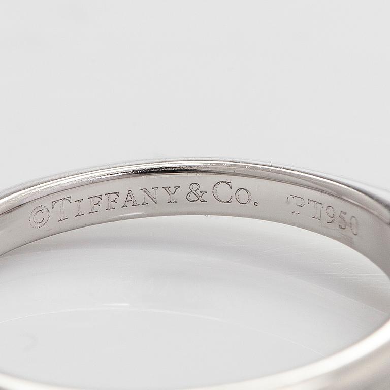 Tiffany & Co, a platinum solitaire ring with a brilliant-cut diamond.