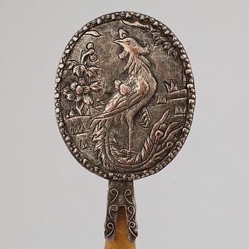 A silver gilt copper mirror with nefrite handle in the shape of a belt hook.