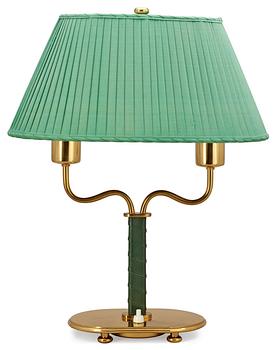 A Josef Frank brass and green leather table lamp by Svenskt Tenn.