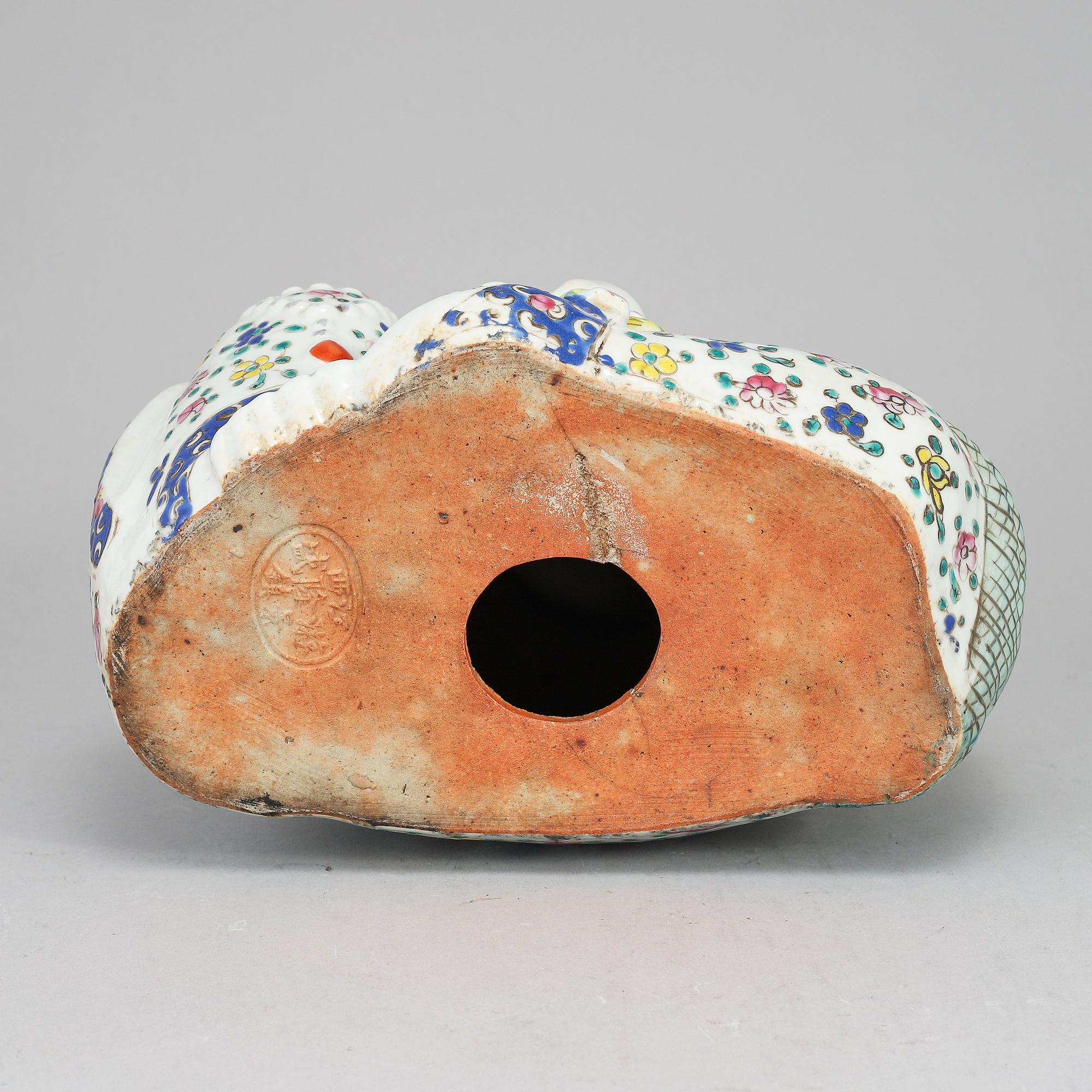 A large famille rose porcelain figure of a buddha with children, 20th century.