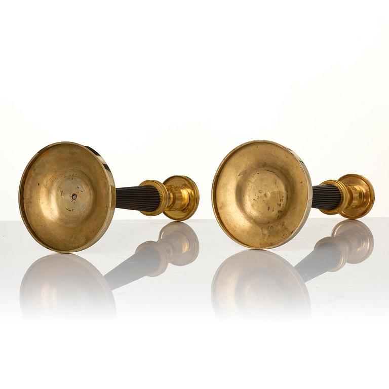 A pair of Empire ormolu and patinated bronze candlesticks.