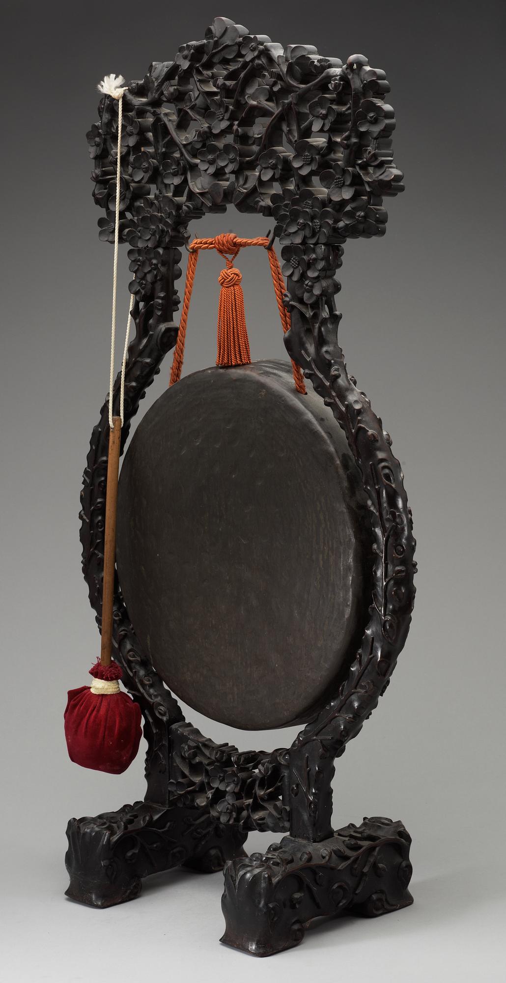 A bronze gong with a wooden stand, Qing dynasty.
