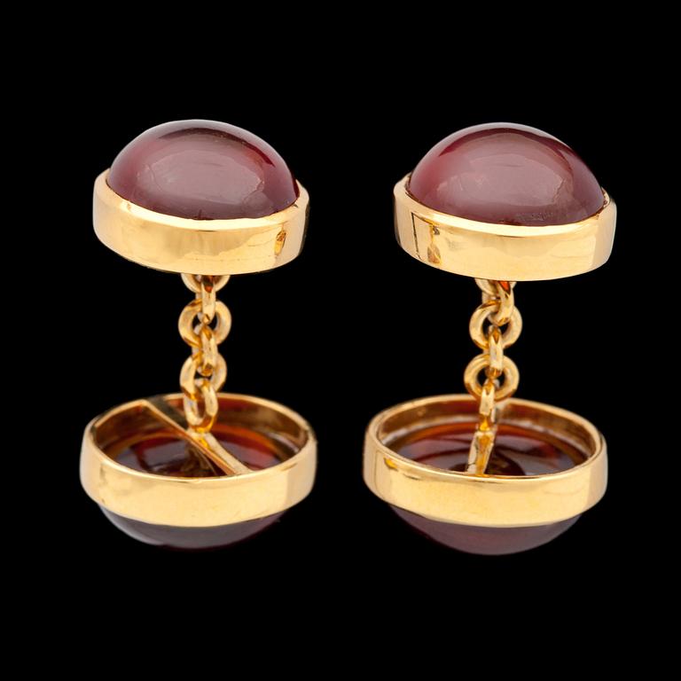 A pair of cabochon cut garnet cufflinks.