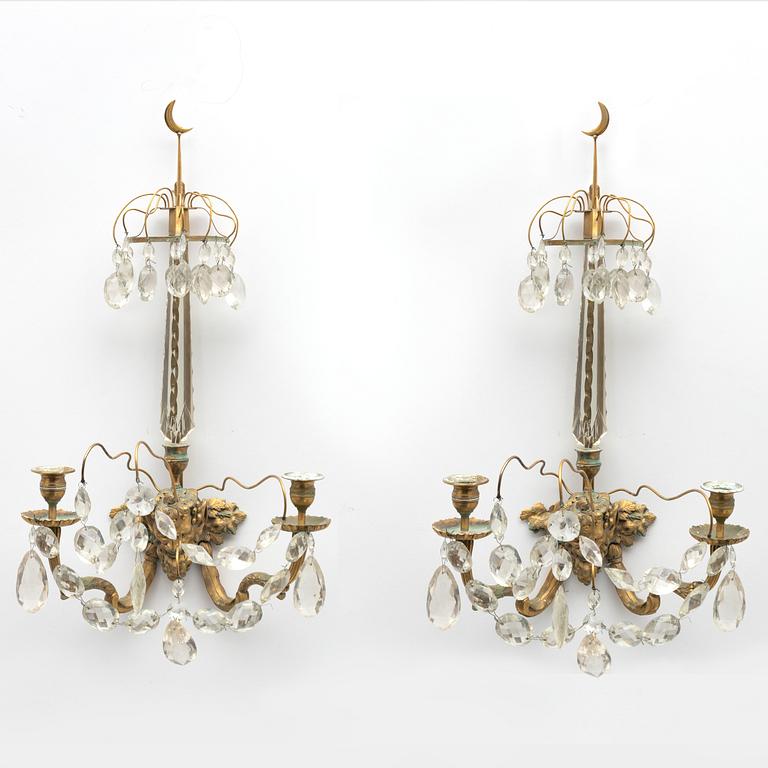 A pair of Louis XVI-style two-branch gilt-bronze and cut-glass appliques, larte 19th century.