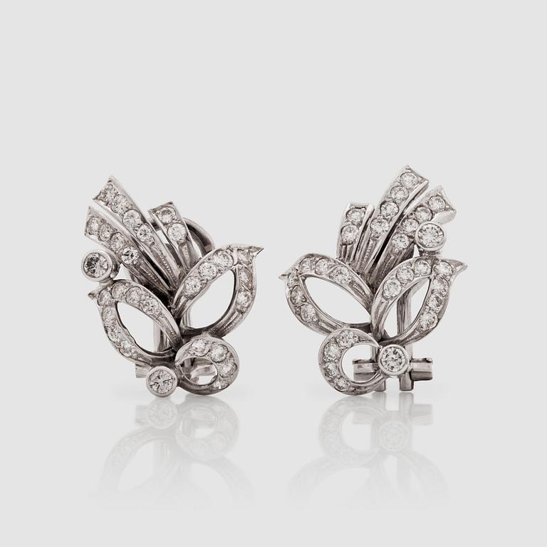 A pair of brilliant-cut diamond earrings.