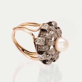 A ring set with a cultured pearl and rose-cut diamonds.