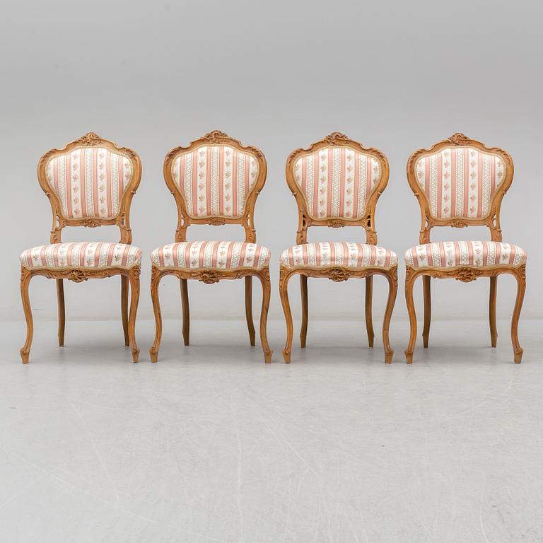 An end of the 19th Century rococo style walnut sofa with four chairs, two armchairs and a table.