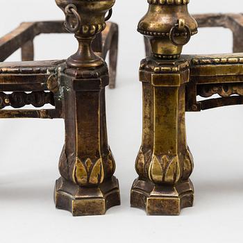 A pair of 19th century Louis XVI style cast iron and brass andirons.