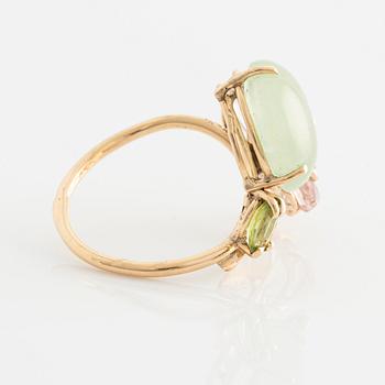 Ring with cabochon-cut prehnite, cut tourmaline in the shape of a butterfly, peridot, and brilliant-cut diamonds.