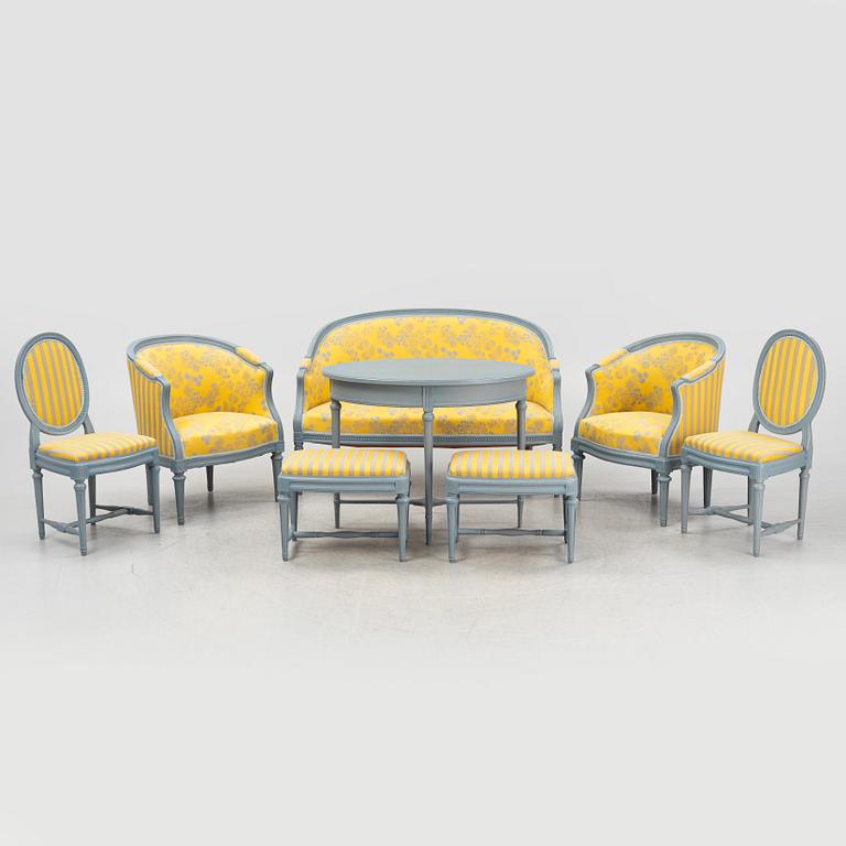 A painted sofa, table, a pair of chairs, a pair of armchairs, a pair of stools, Gustavian style, 20th Century.