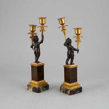 A pair of bronze empire style candleabra, 20th century.