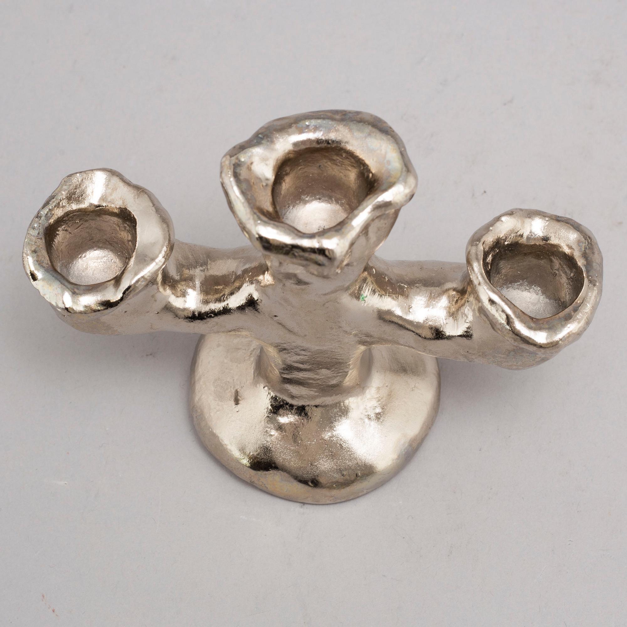 DAN WOLGERS, a silvergilt bronze candle stick, signed.