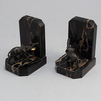 a pair of bronze and stone bookends from the first half of the 20th century.