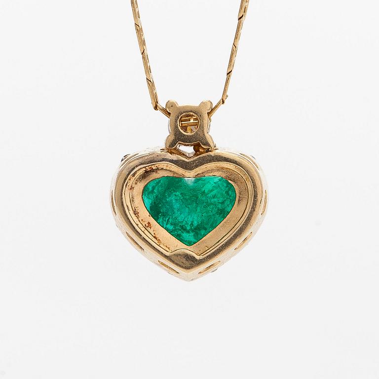 An 18K gold necklace and pendant with heart-shaped emerald and diamonds.