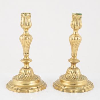 A pair of French Louis XV brass candlesticks, mid 18th century.