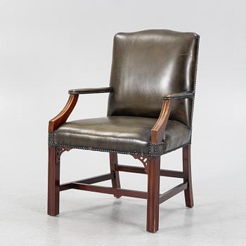 A 20th Century leather upholstered mahogany armchair.