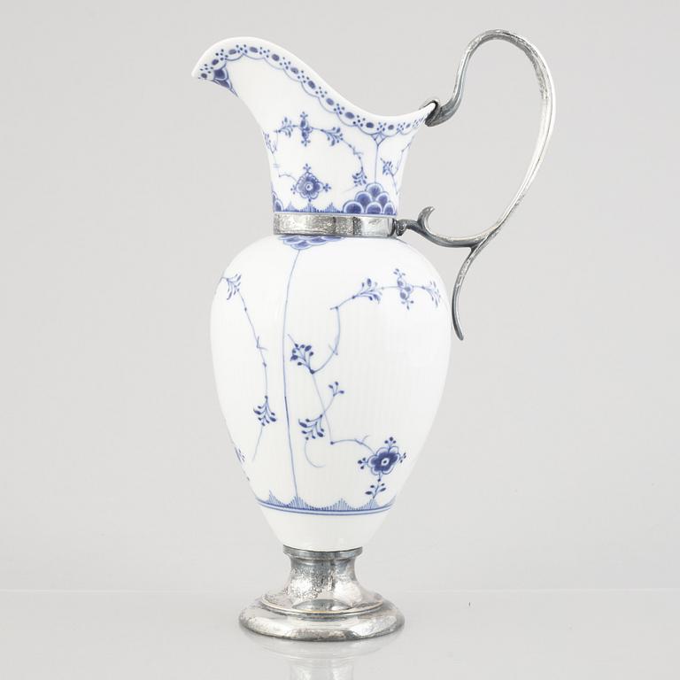 A 'Blue Fluted Half Lace' / 'Musselmalet' porcelain decanter with metal fittings, Royal Copenhagen, 19th century.