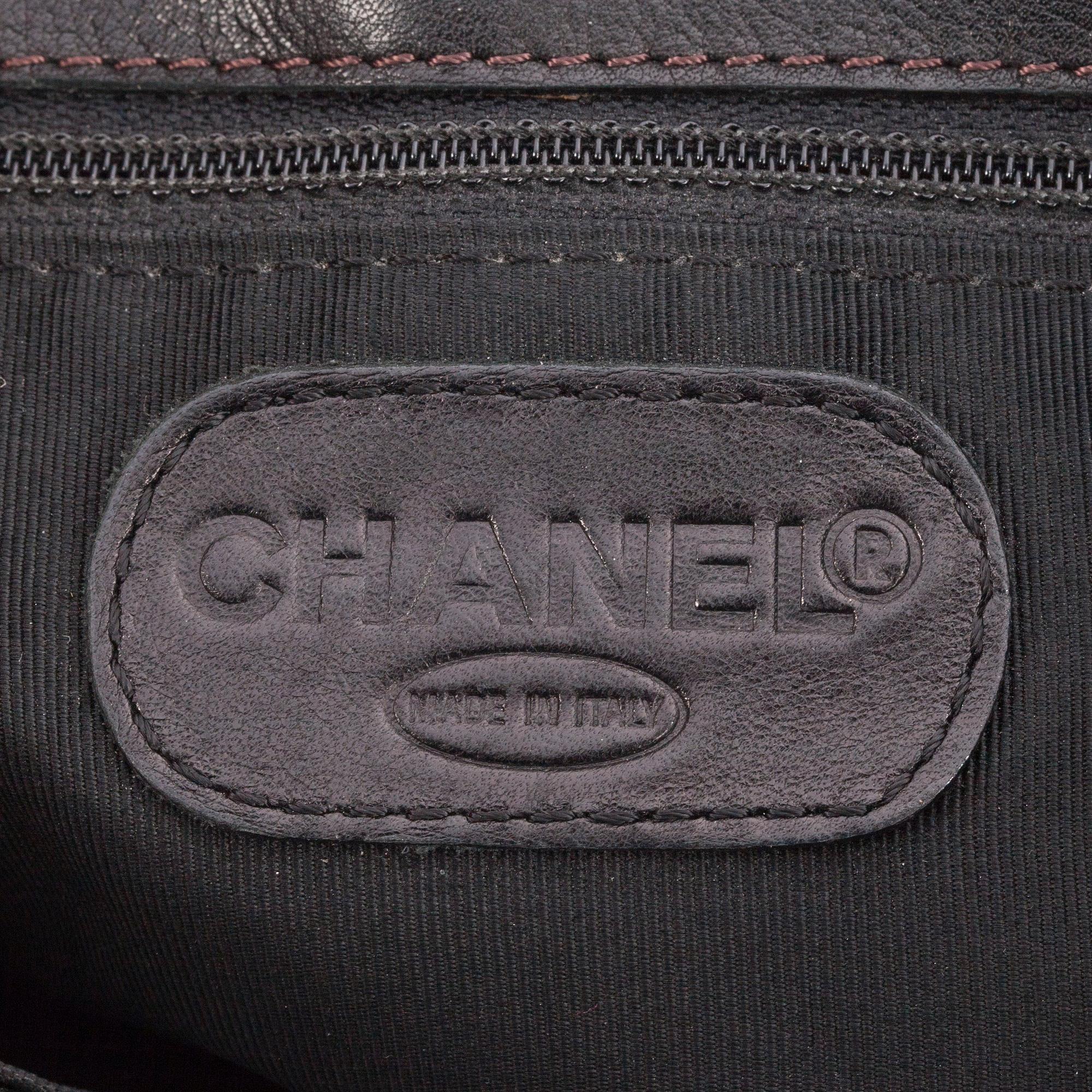 CHANEL, a black leather tote bag.