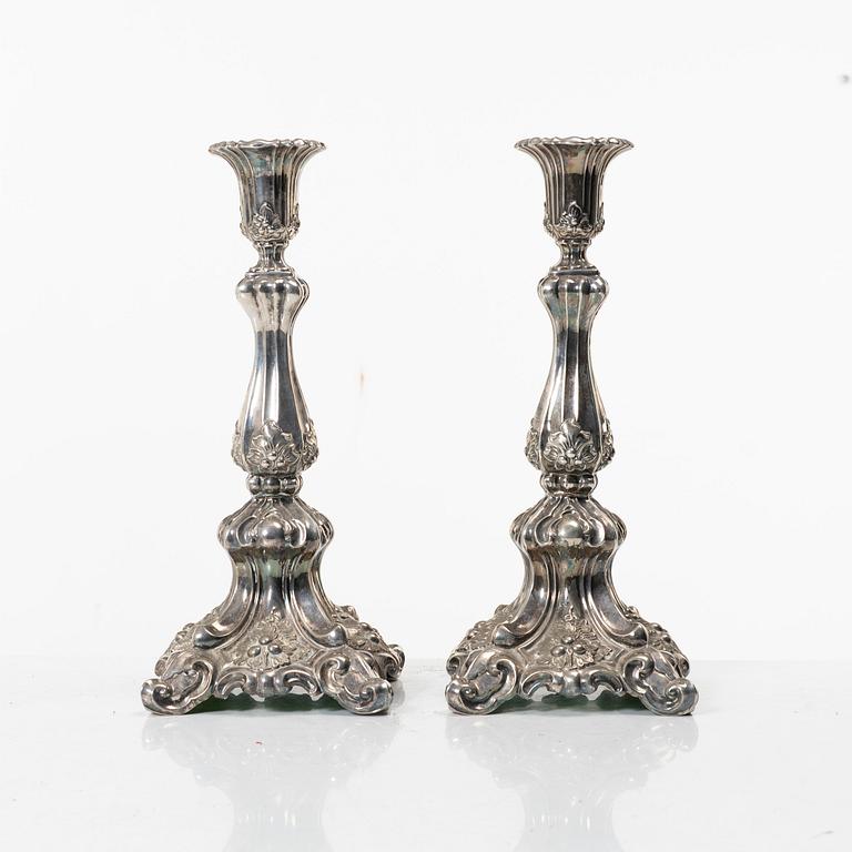A pair of rococo-style silver candle sticks, early 20th century.