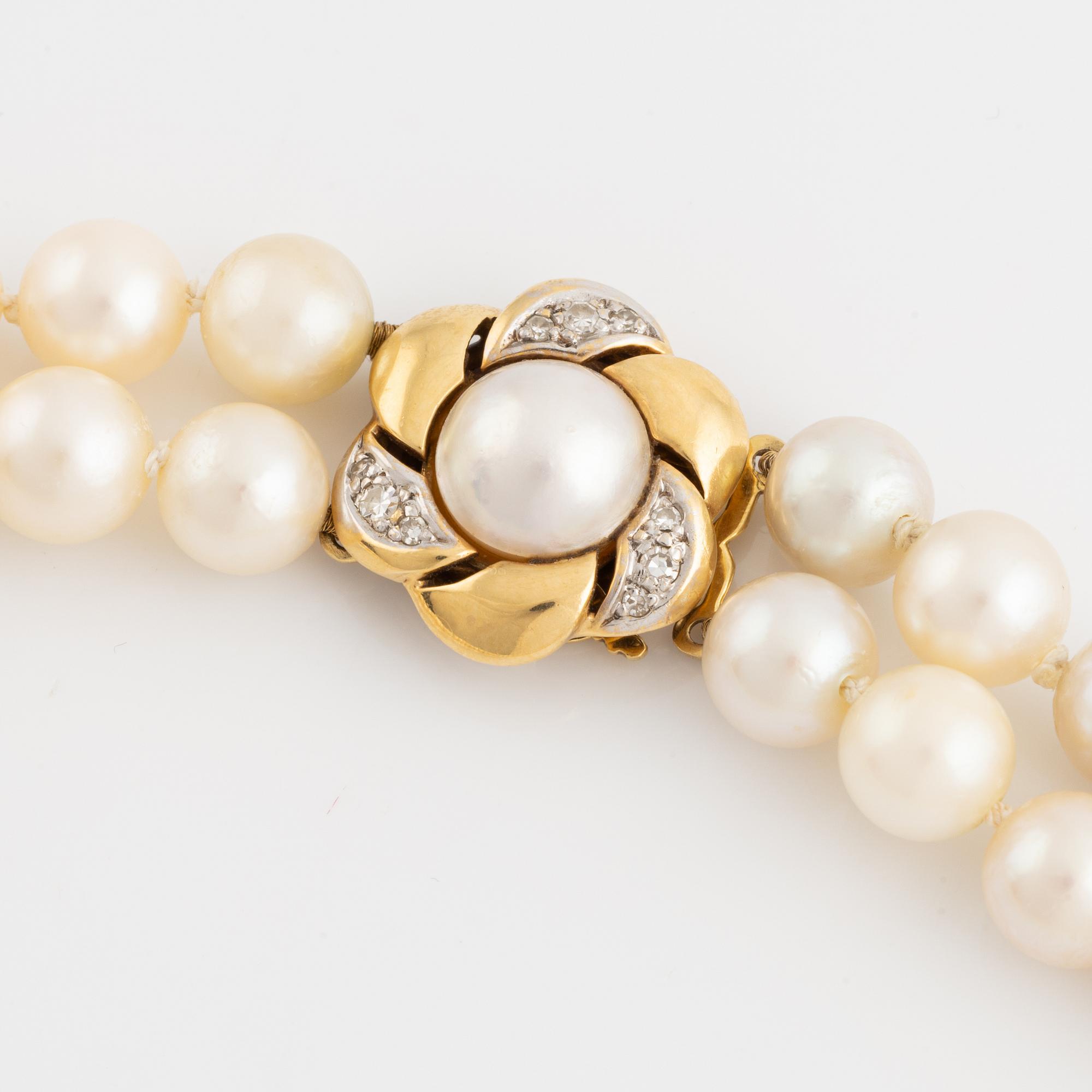 Two strand cultured pearl necklace, clasp 18K gold with half pearl and eight cut diamonds.
