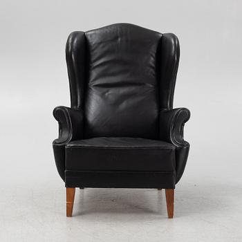 A leather upholstered wingback chair, 20th Century.