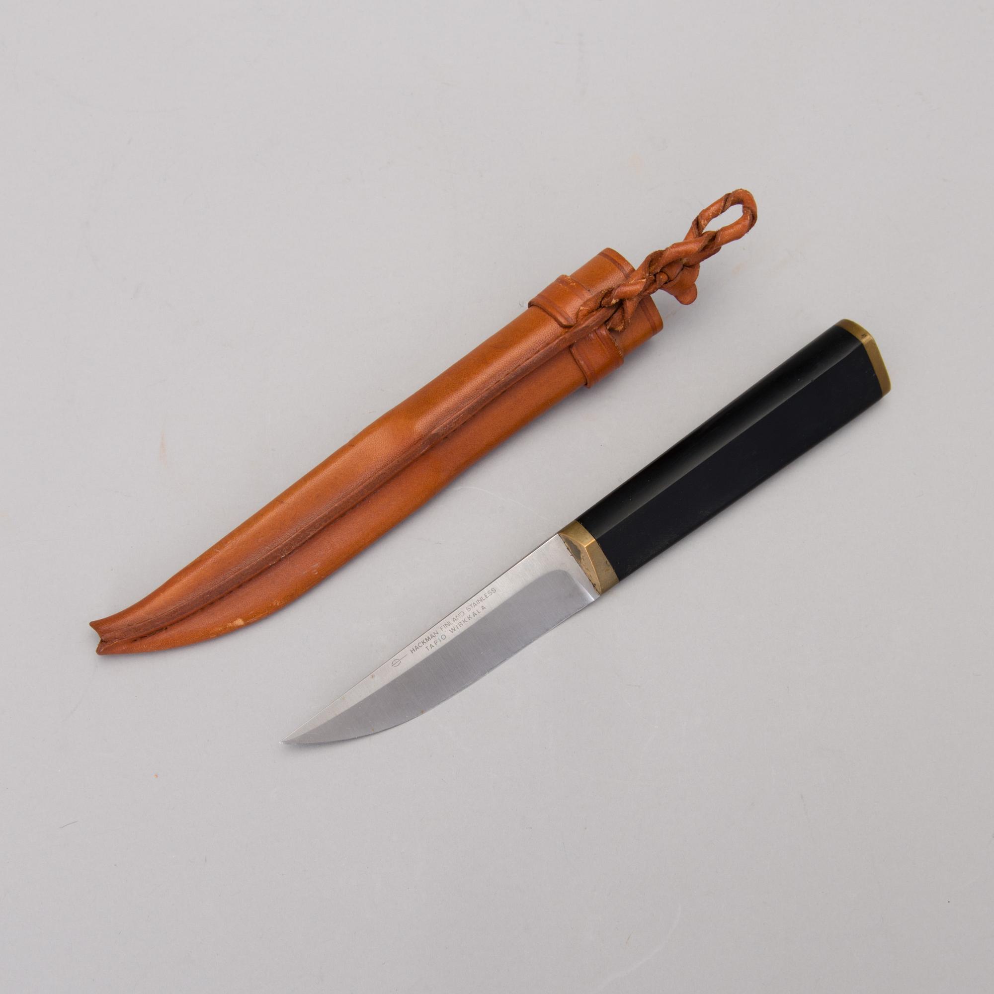 A Finnish puukko knife in stainless steel, nylon and brass
