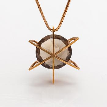 A 14K gold necklace with a smoky quartz. Martti Tapio Aarnio, Helsinki 1966.