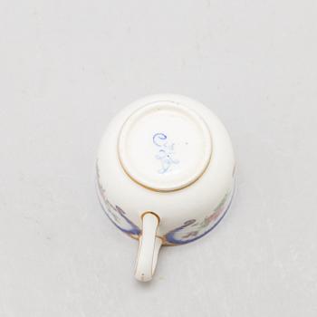 A pair of enamelled cups with dishes, France, Sèvres, 1780s.