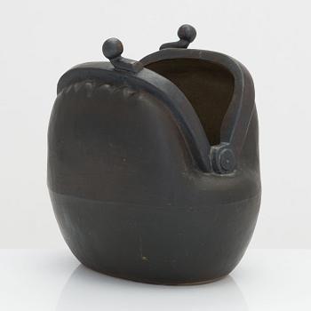 Outi Leinonen, a ceramic vase formed as a purse for Pentik, Finland.
