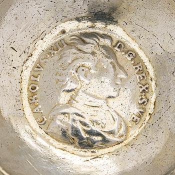 A silver tumbler with inset Swedish coin dated 1713.