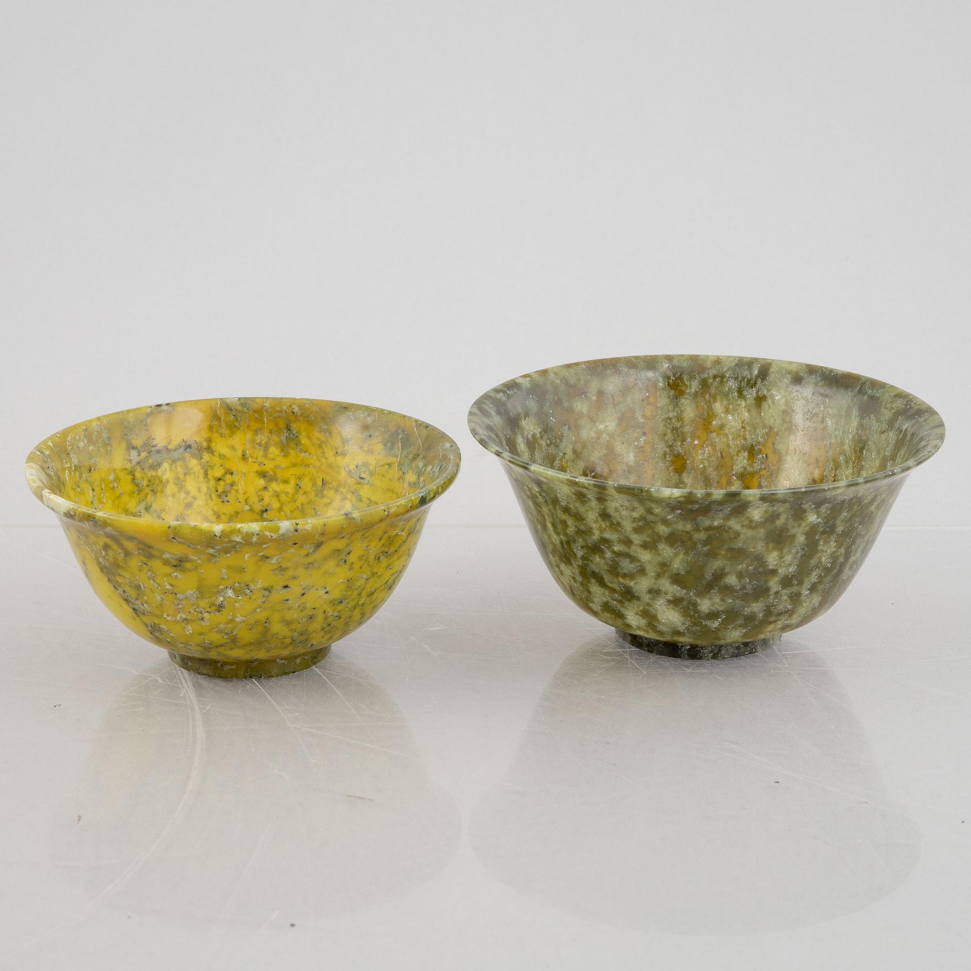 A group of ten Chinese spinach green stone bowls.