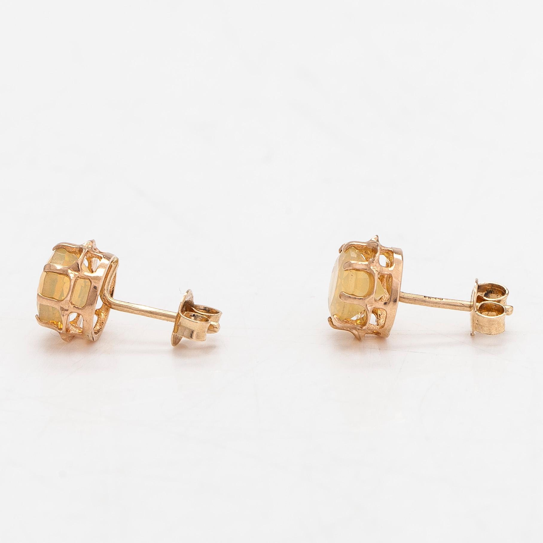 A pair of 14K gold earrings with opals.