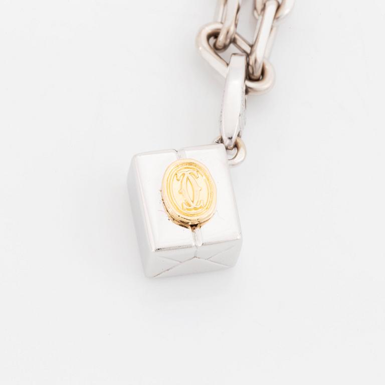 An 18K gold and white gold Cartier necklace with a charm.