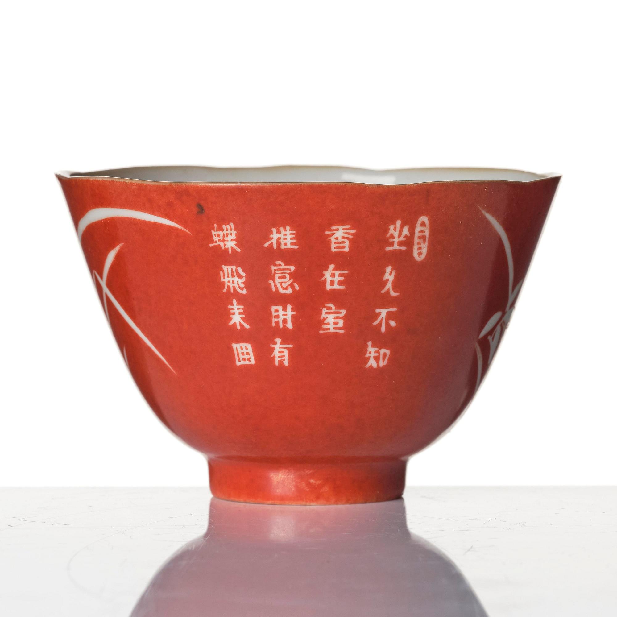 A coral-ground reserve decorated 'orchids' cup, late Qing dynasty.