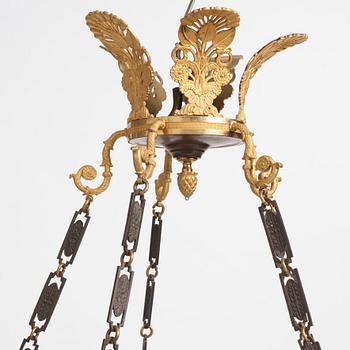 An Empire.style five-branch patinated and gilt bronze chandelier, later part of the 19th century.