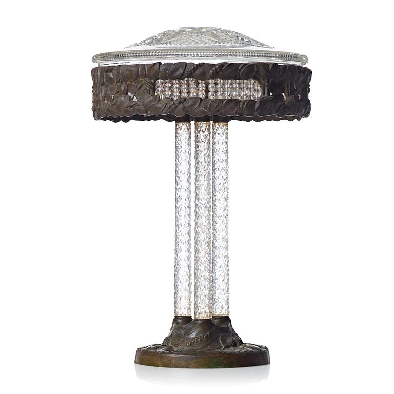 A Swedish Art Nouveau patinated brass and cut glass table lamp, Böhlmark's, Stockholm 1909-20.