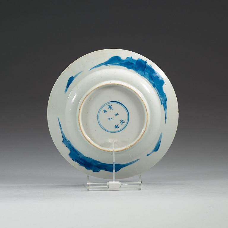 A set of four odd blue and white dinner plates, Qing dynasty, Kangxi (1662-1722), with different six character marks.