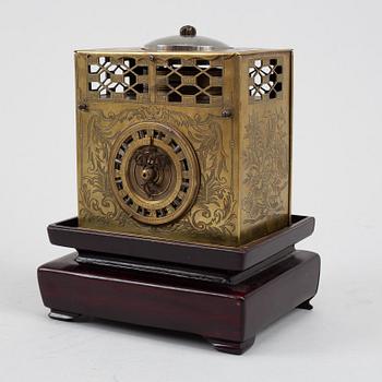 A Japanese brass mantel clock, 19th Century.