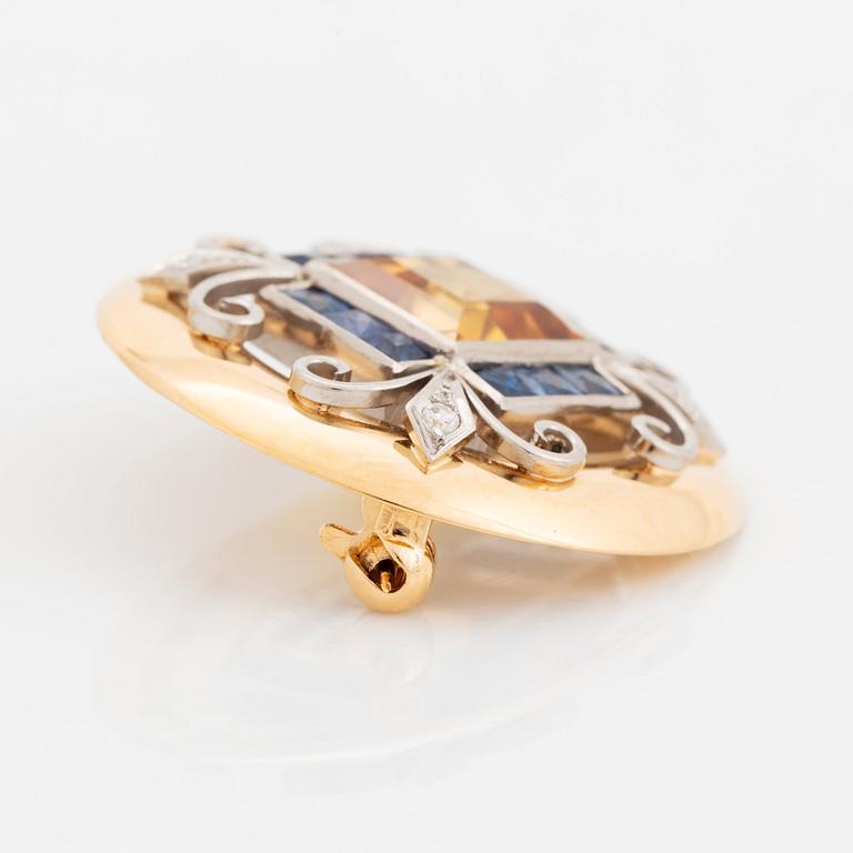 An 18K gold brooch set with a step-cut yellow sapphire possibly synthetic.