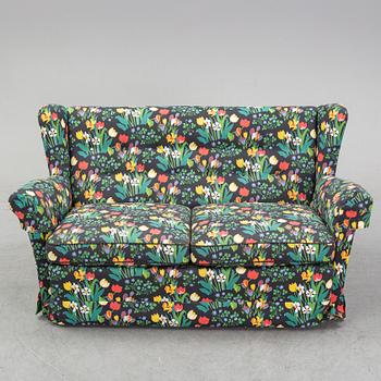 A sofa and wingback chair, later part of the 20th Century.