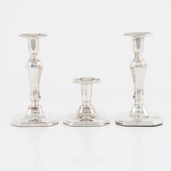 A pair of silver candlesticks, MGAB, Uppsala, 1985 and a silver candlestick, MEMA, Lidköping, 1987.