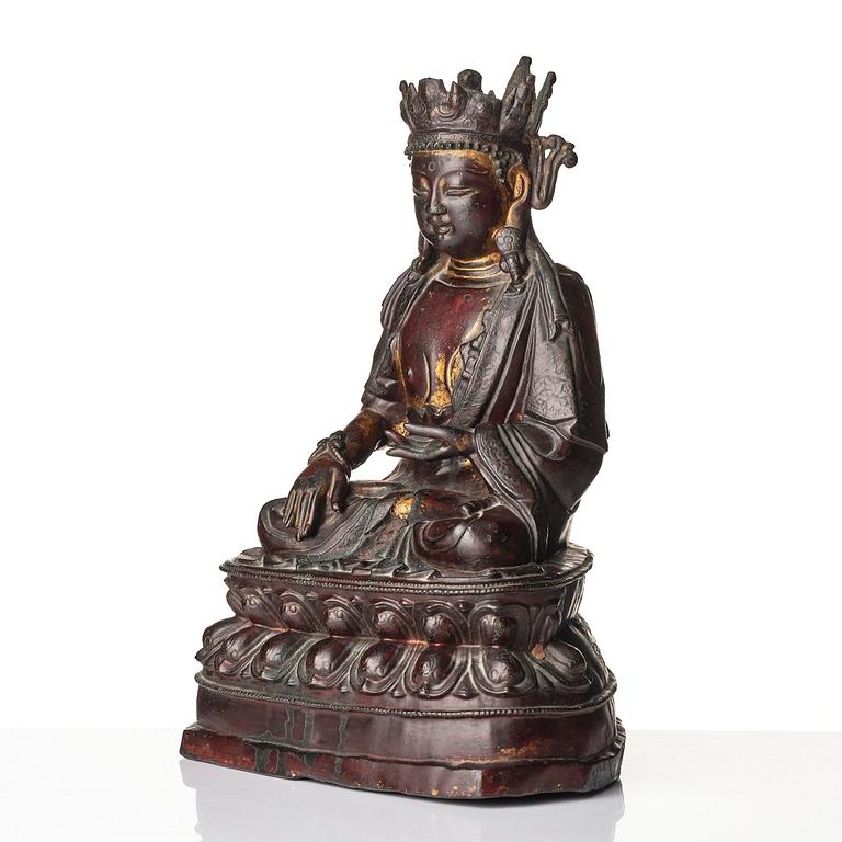 A bronze sculpture of a crowned Buddha, presumably late Ming dynasty, with an inscription dating it as 1530.