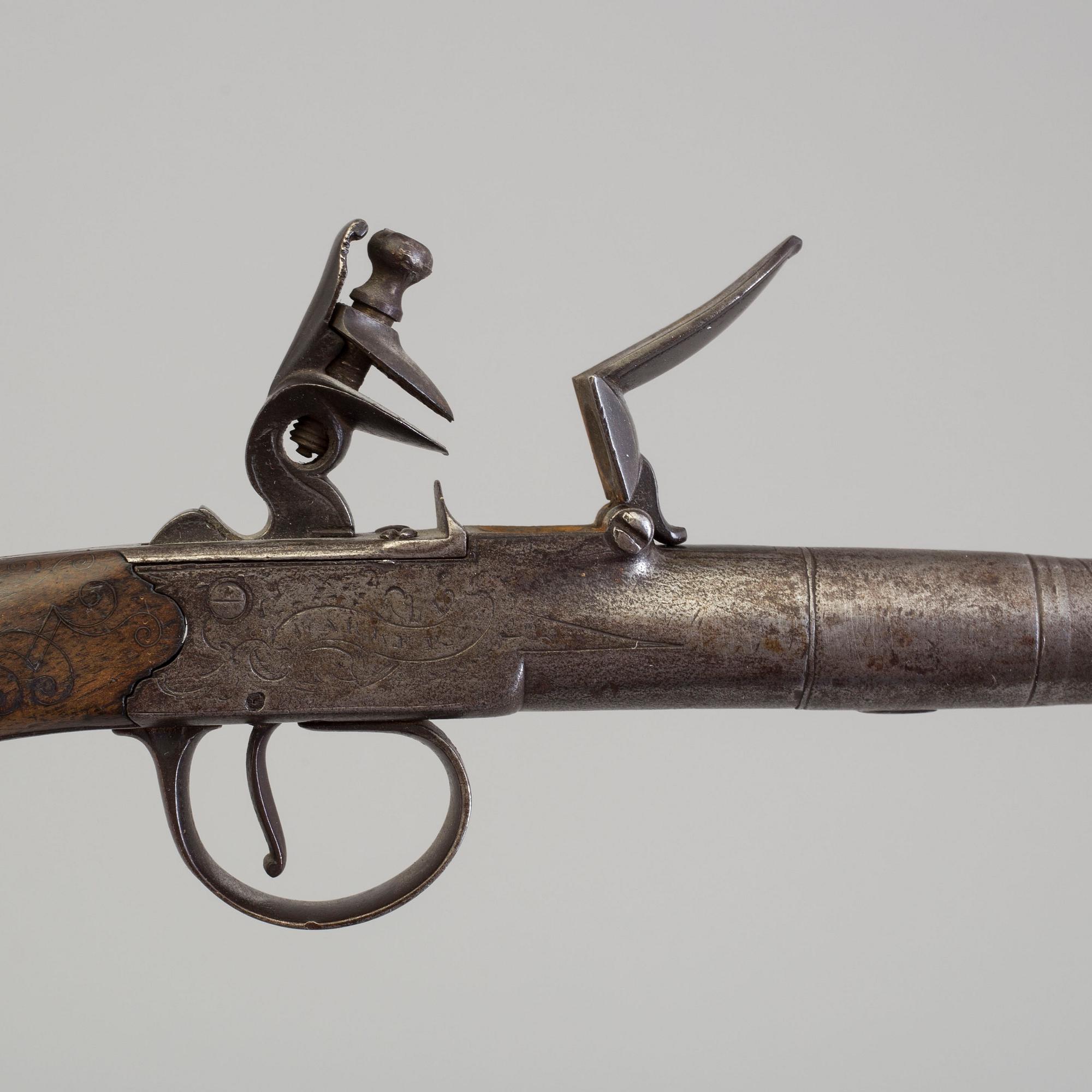 A pair of Queen Anne flintlock pistols makers mark Barker and London proof marks.