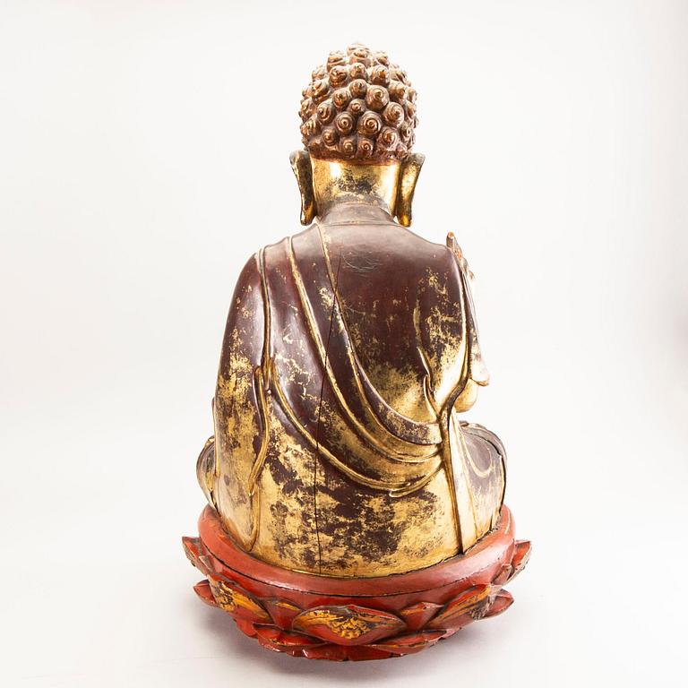 A large gilt and lacquered figure of a seated buddha, Qing dynasty, 19th Century.